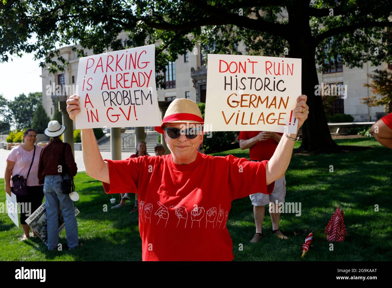 Stephanie Connor, a 16 year resident of German Village, holds signs