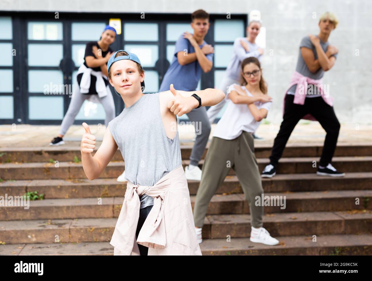 Happy positive teenagers learn dance movements at street Stock Photo ...