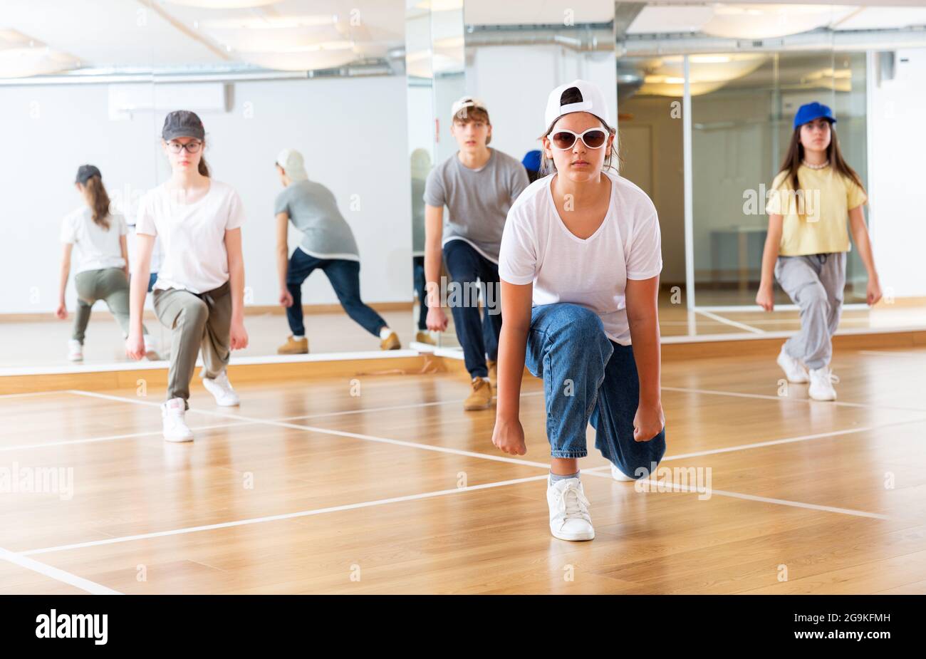 Teenagers training hip hop in dance studio Stock Photo - Alamy