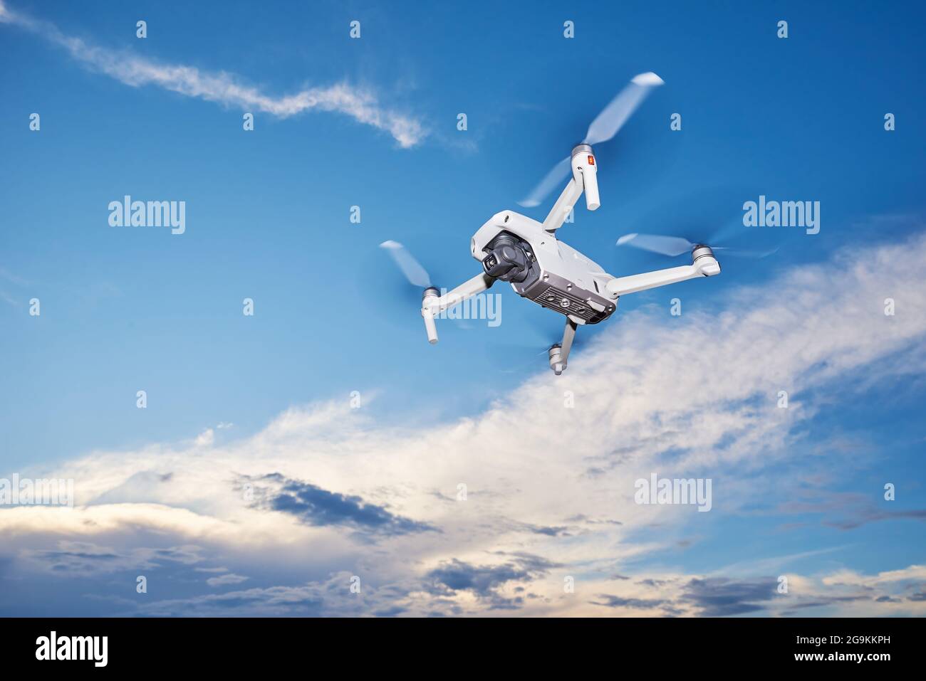 Modern drone with camera in the sky. Flying quadcopter Stock Photo