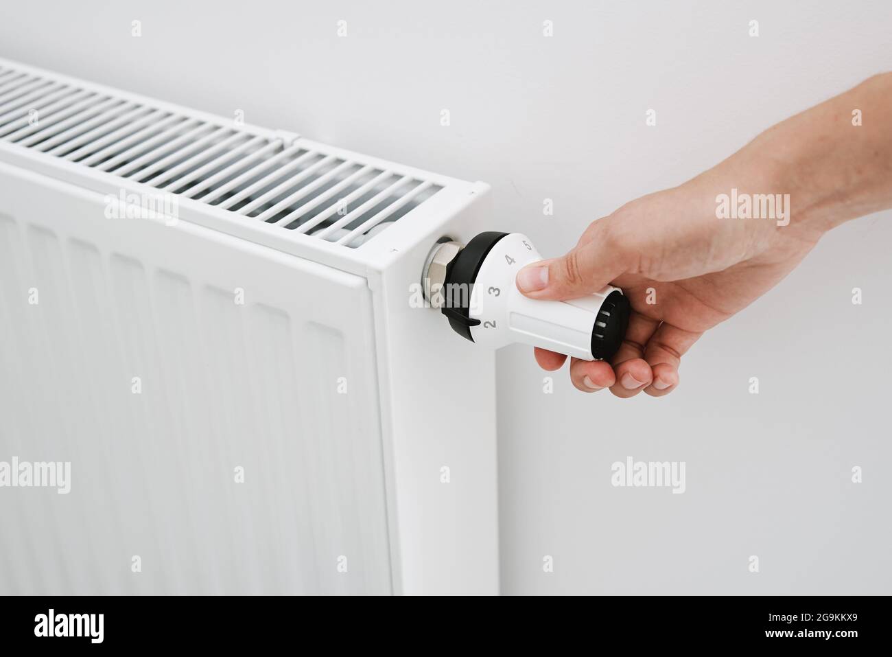 Heat radiator knob. Woman hand adjusting temperature on heating radiator Stock Photo Alamy