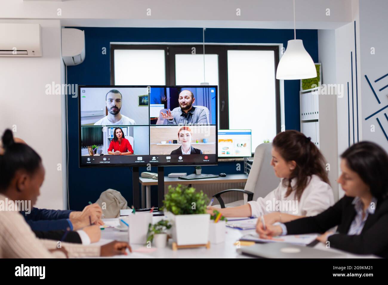 Emplyees workers having webcam group conference with coworkers speaking on video call. Business people talking to webcam, do online conference participate internet brainstorming, distance office discussion. Stock Photo