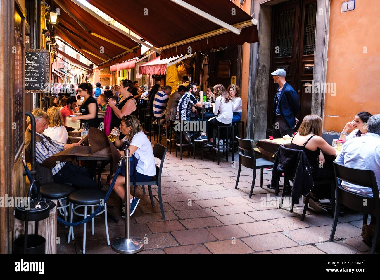 Diners enjoying the food and ambience in the Quadrilatero area of Bologna Italy Stock Photo