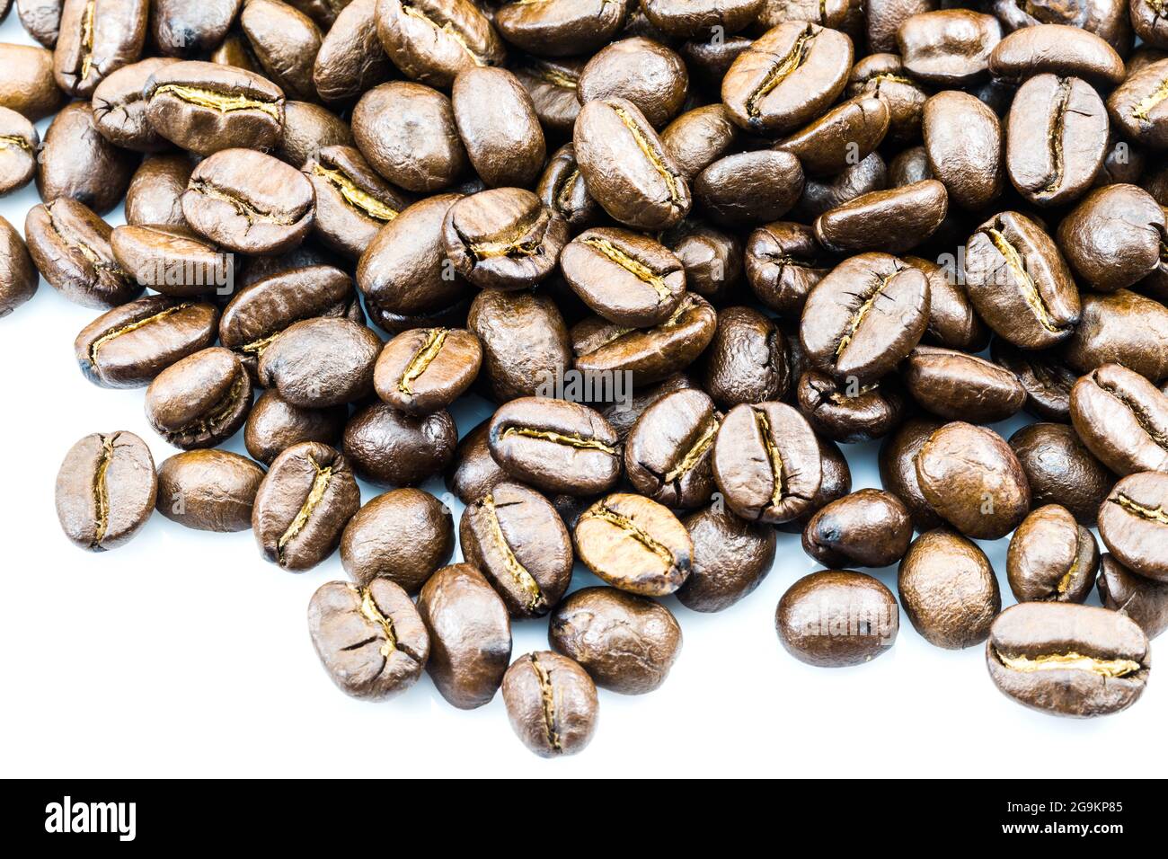 Brown coffee beans isolated on white background Stock Photo - Alamy