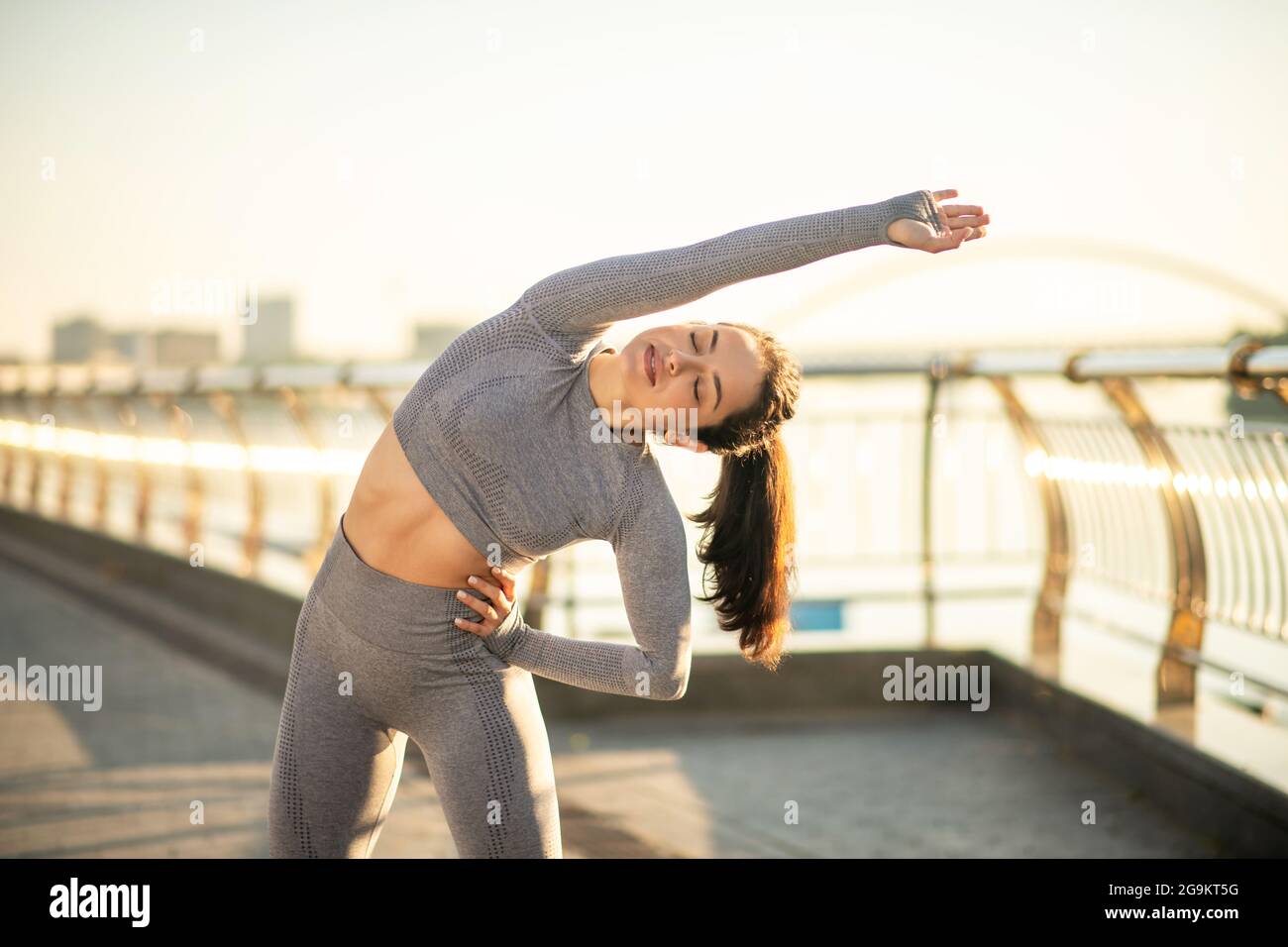 Young female sportsperson having a workout outside Stock Photo