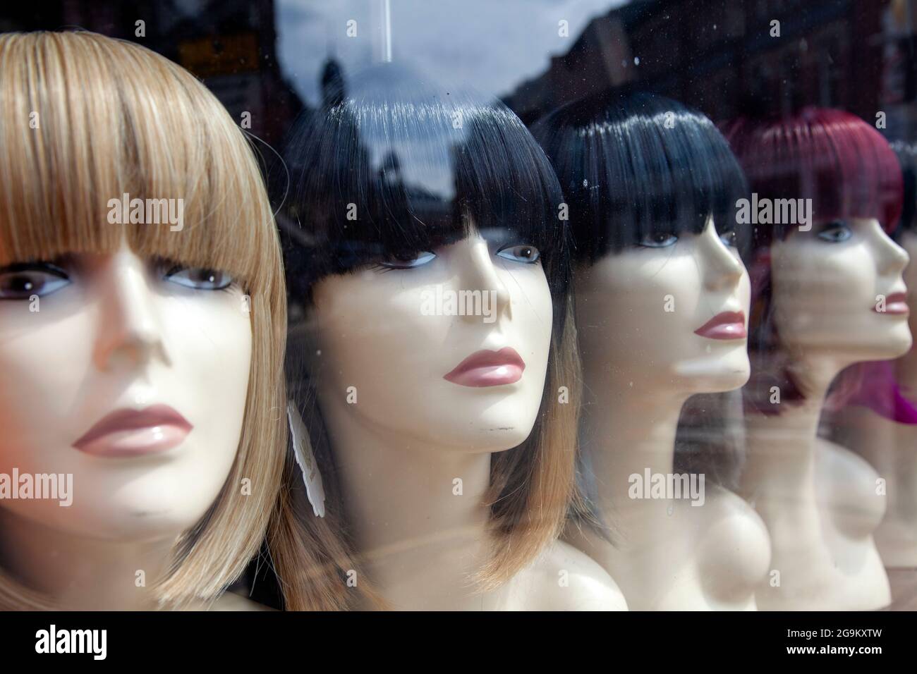 Mannequins Displaying Wings in Shop Window Stock Photo