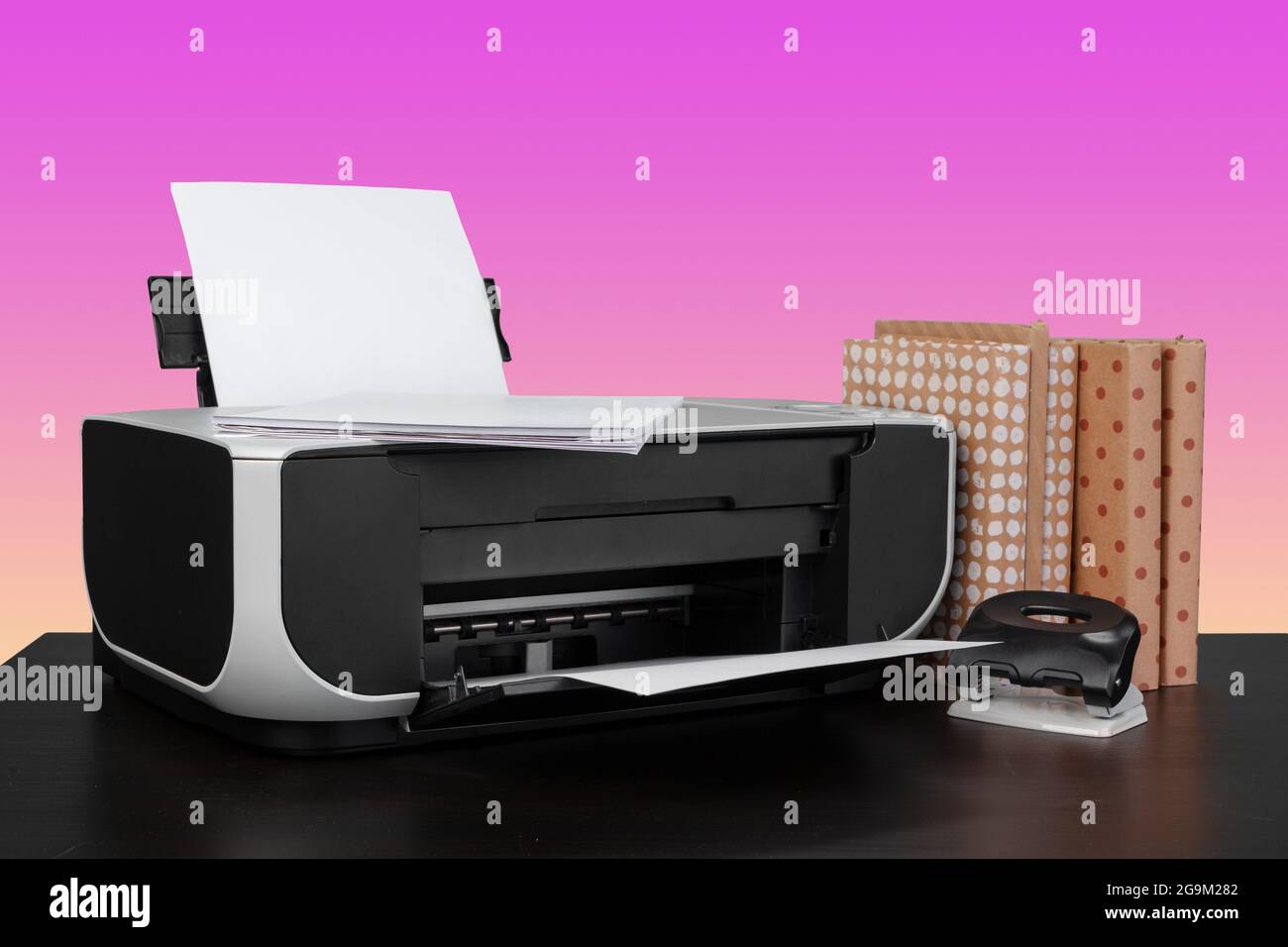 Compact home laser printer against pink background Stock Photo