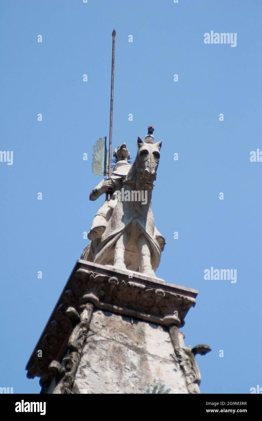 Portrait of a dramatic stone statue of a knight on a horse with a lance Stock Photo