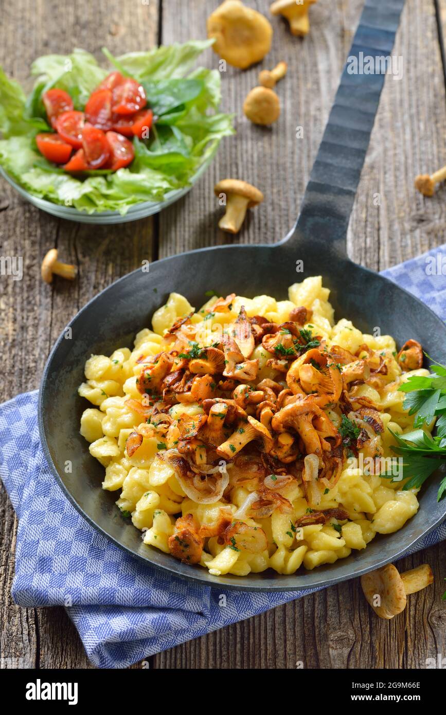Vegetarian German spaetzle with fried chanterelles and onions served in