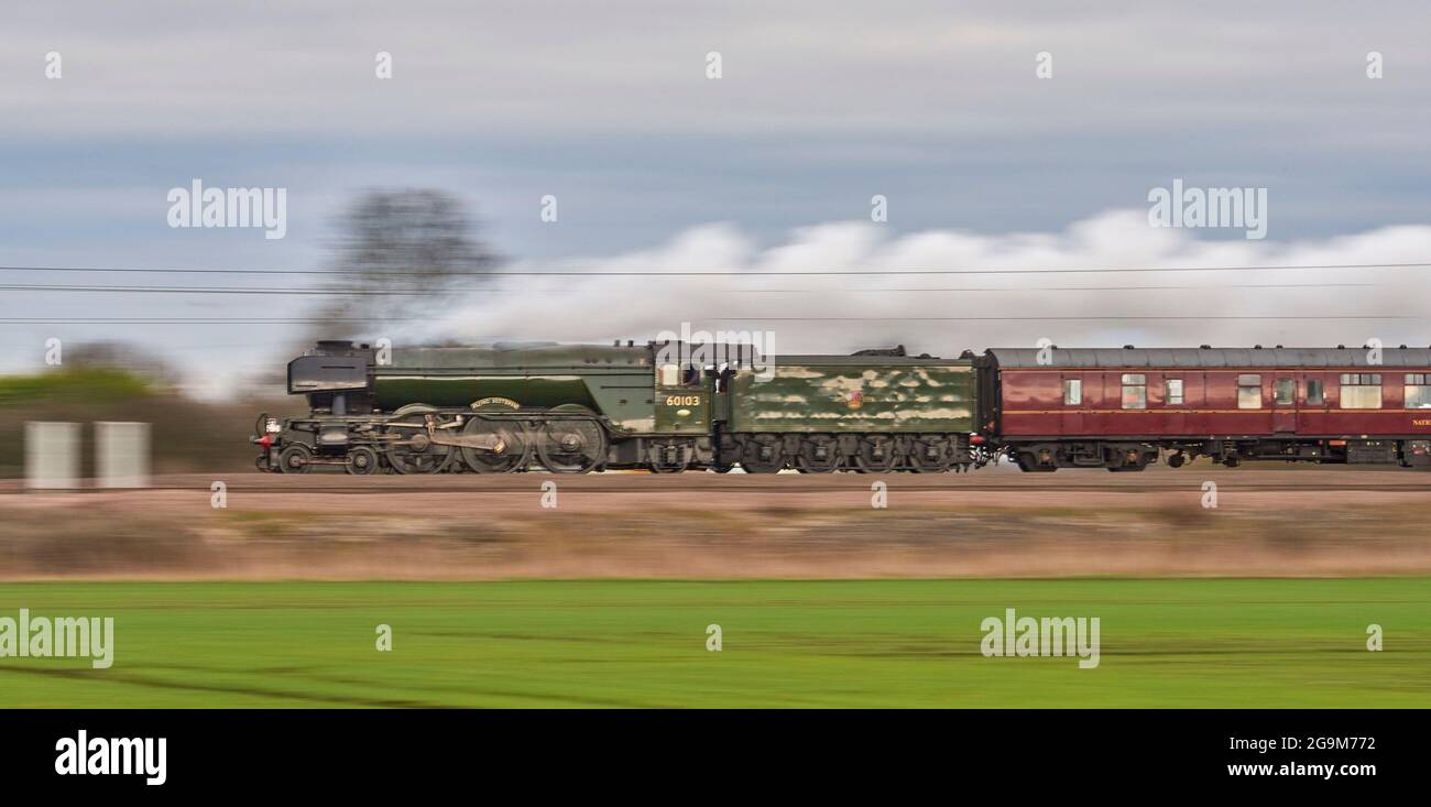 Preserved steam locomotive Flying Scotsman, at Speed, on the mainline rail network hauling a special passenger train south of Selby, North Yorkshire, Stock Photo