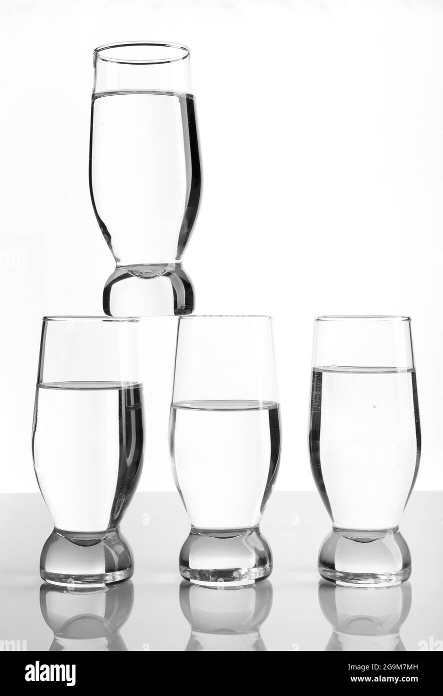 Glasses of water on light background Stock Photo - Alamy