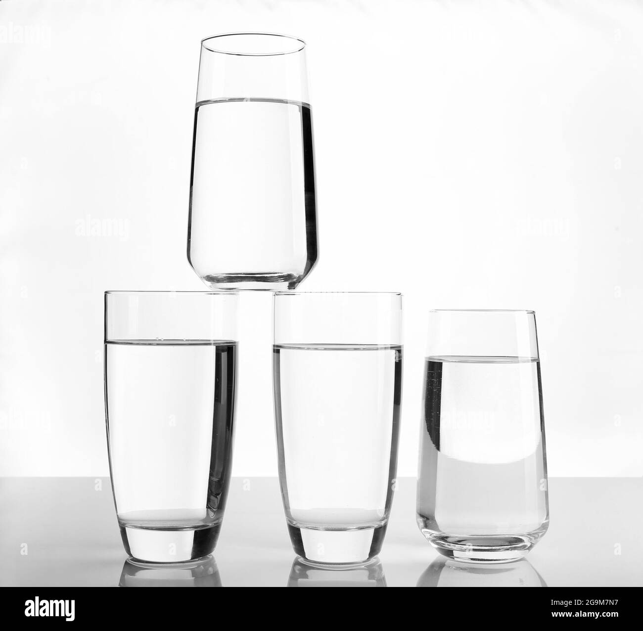 Glasses of water on light background Stock Photo Alamy