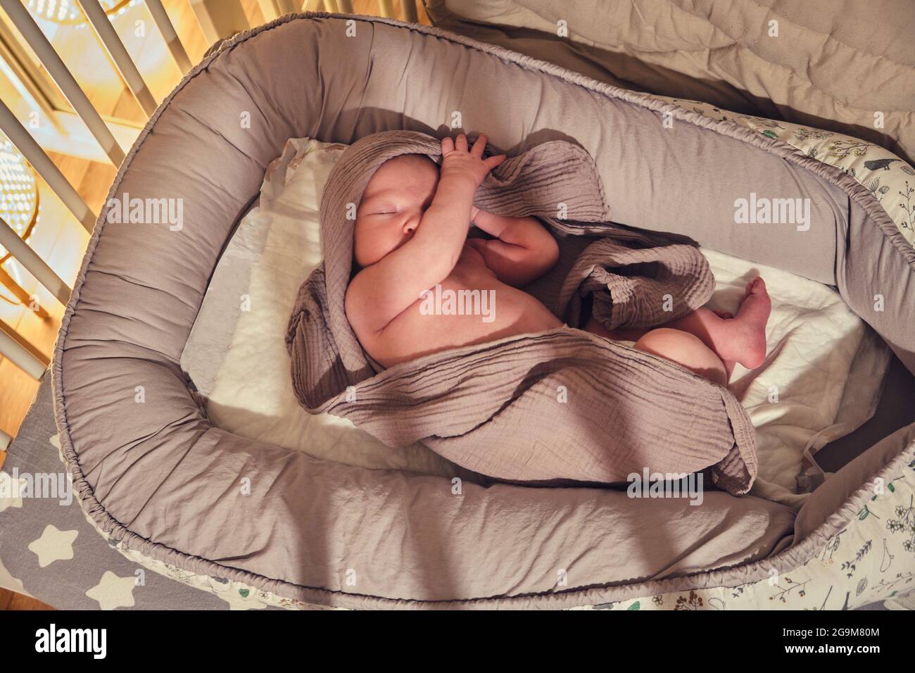 Baby Sleeping In Crib With Blanket