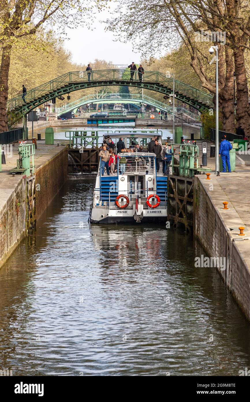 Tourist boat waiting in a lock of the Saint Martin canal in Paris Stock Photo