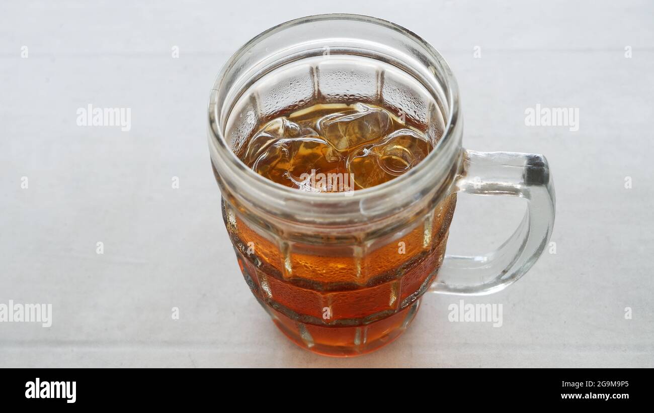 Yogyakarta-27 Juli 2021 Very fresh iced tea drink with lots of ice cubes on a white background Stock Photo