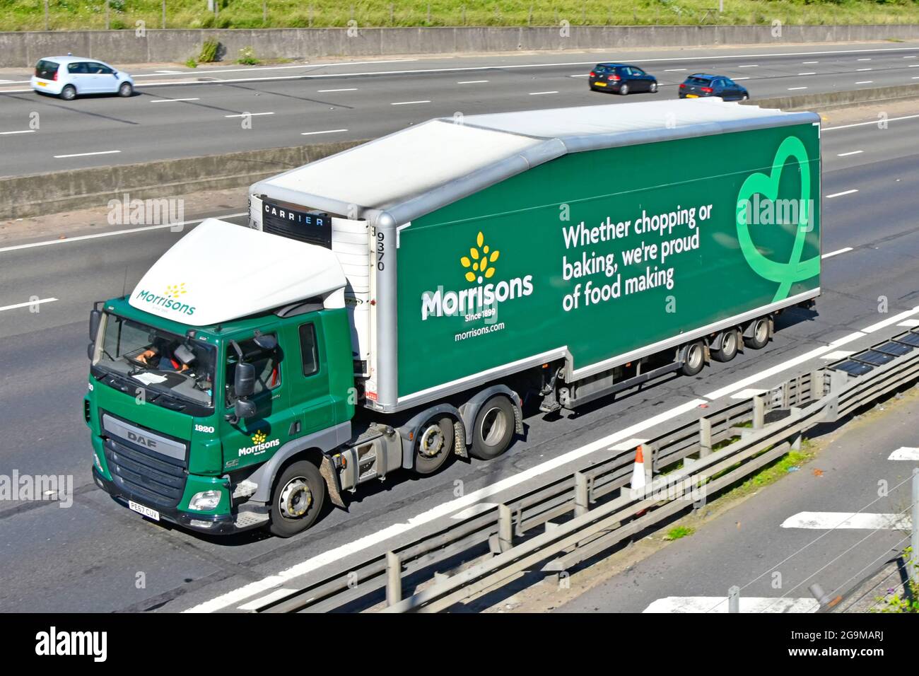 Side front & top view of Morrisons supermarket lorry truck advertising graphics & brand name logo store delivery food supply chain trailer UK motorway Stock Photo