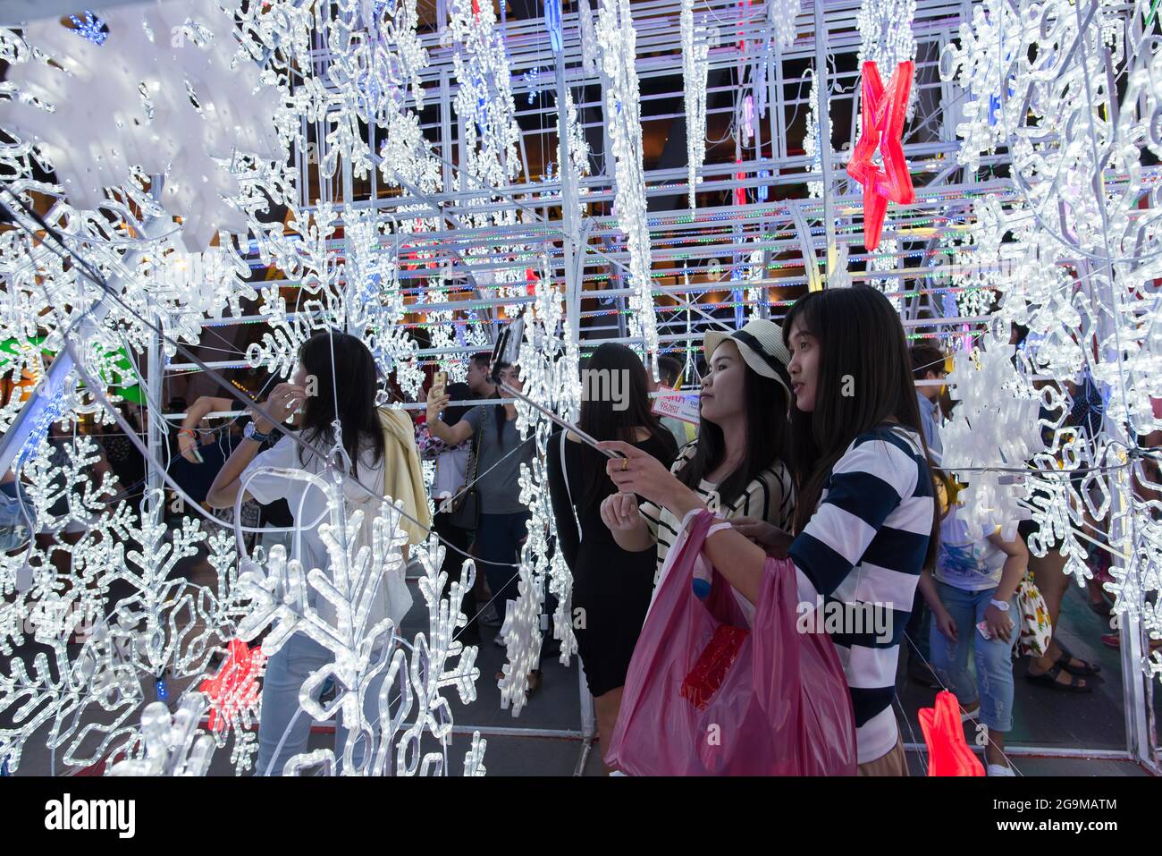 Bangkok, Thailand, 28 Nov 2015, Two young ladies take a selfie in the middle of Christmas decorations in front of Central World. Stock Photo