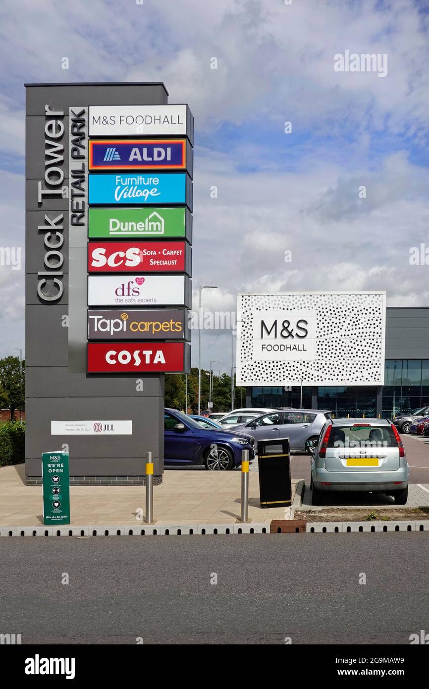 Clock Tower sign listing business brand name logos of store premises on small retail park on site of old Britvic factory Chelmsford Essex England UK Stock Photo