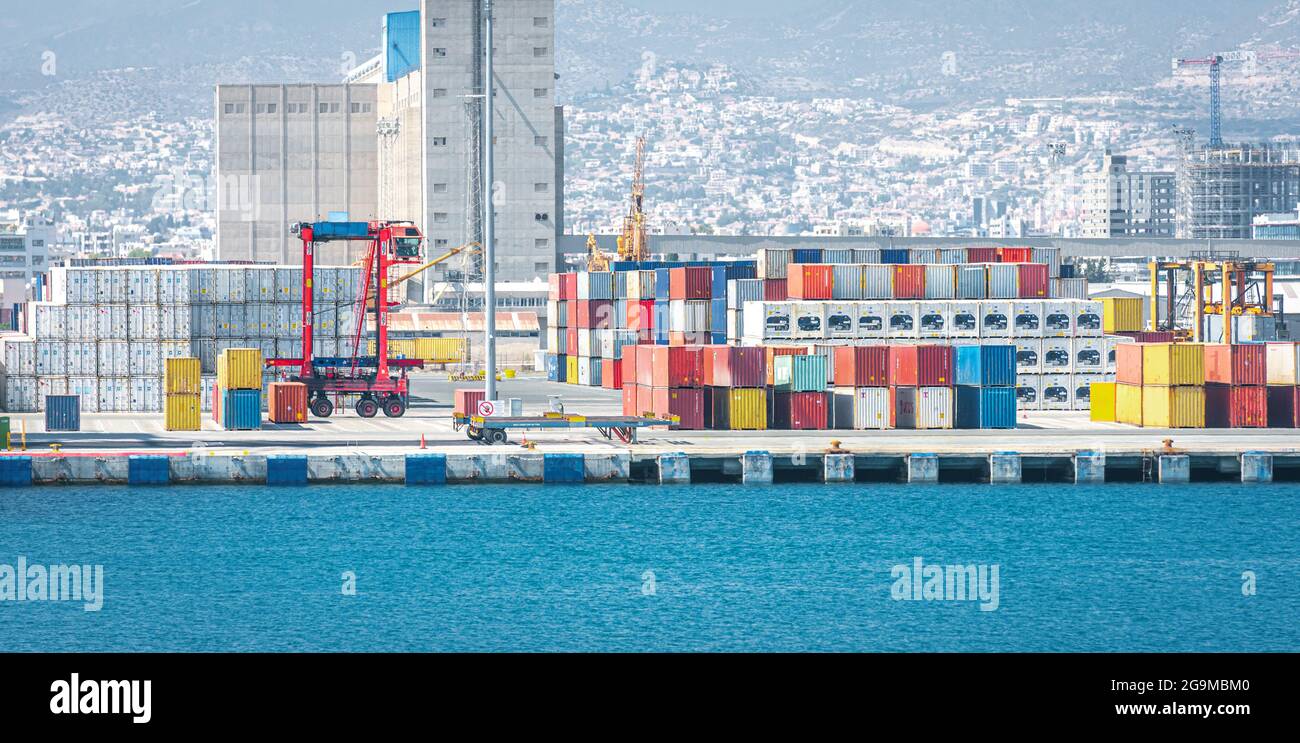 Warehouse and shipping container carriers at the port of Limassol, Cyprus Stock Photo