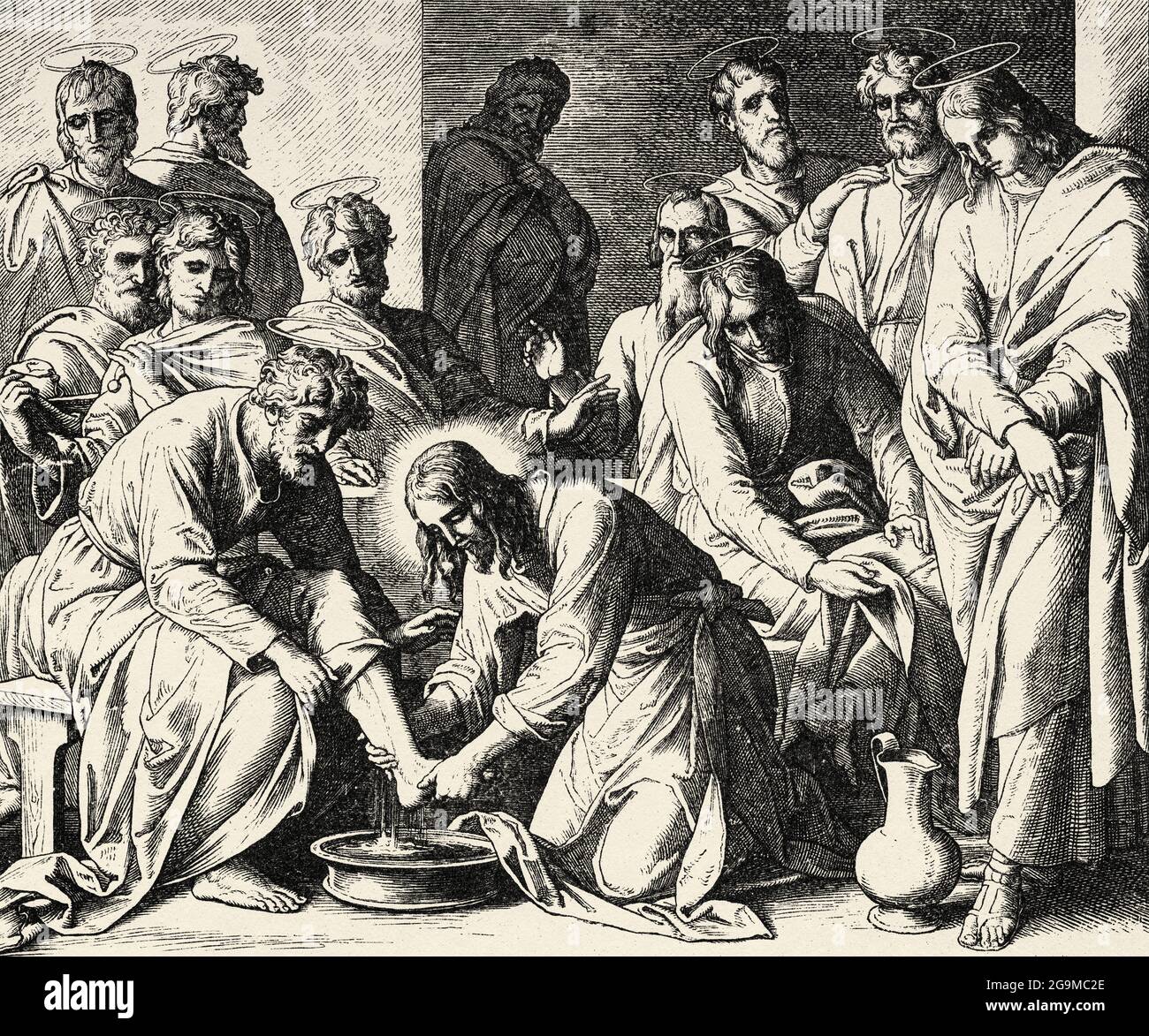 The foot washing. Our Lord Jesus the son of God washes the feet of his disciples. John book, New Testament Sacred biblical history. Old engraving from the book Historia Sagrada 1920 Juan Lagui Lliteras Stock Photo