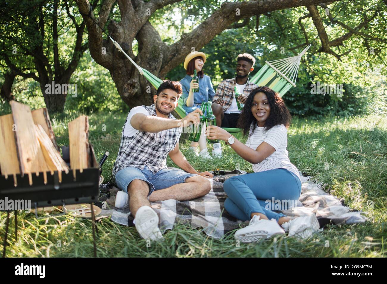 Happy Young Multiethnic People Chilling Together At Green Summer Park