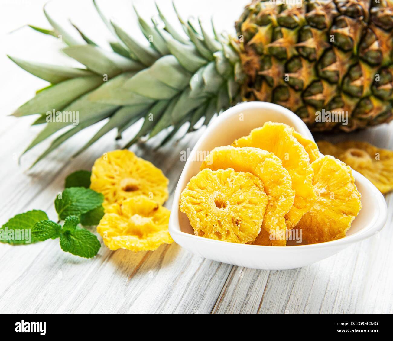 Pineapple dried rings on rustic wooden background Stock Photo