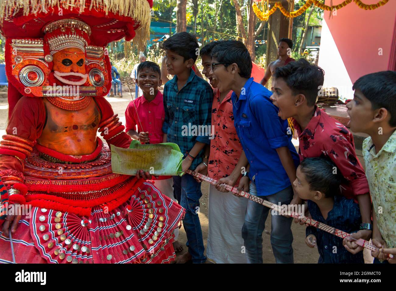Theyyam (Teyyam, Theyam, Theyyattam) is a popular ritual form of dance worship in Kerala and Karnataka, India. Theyyam consisted of several thousand-y Stock Photo