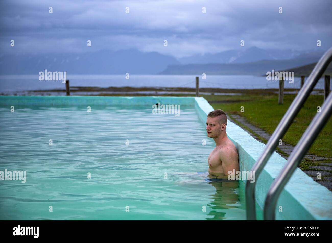 Boy bathes in Reykjafjardarlaug Hot Pool located in the Westfjords, Iceland Stock Photo