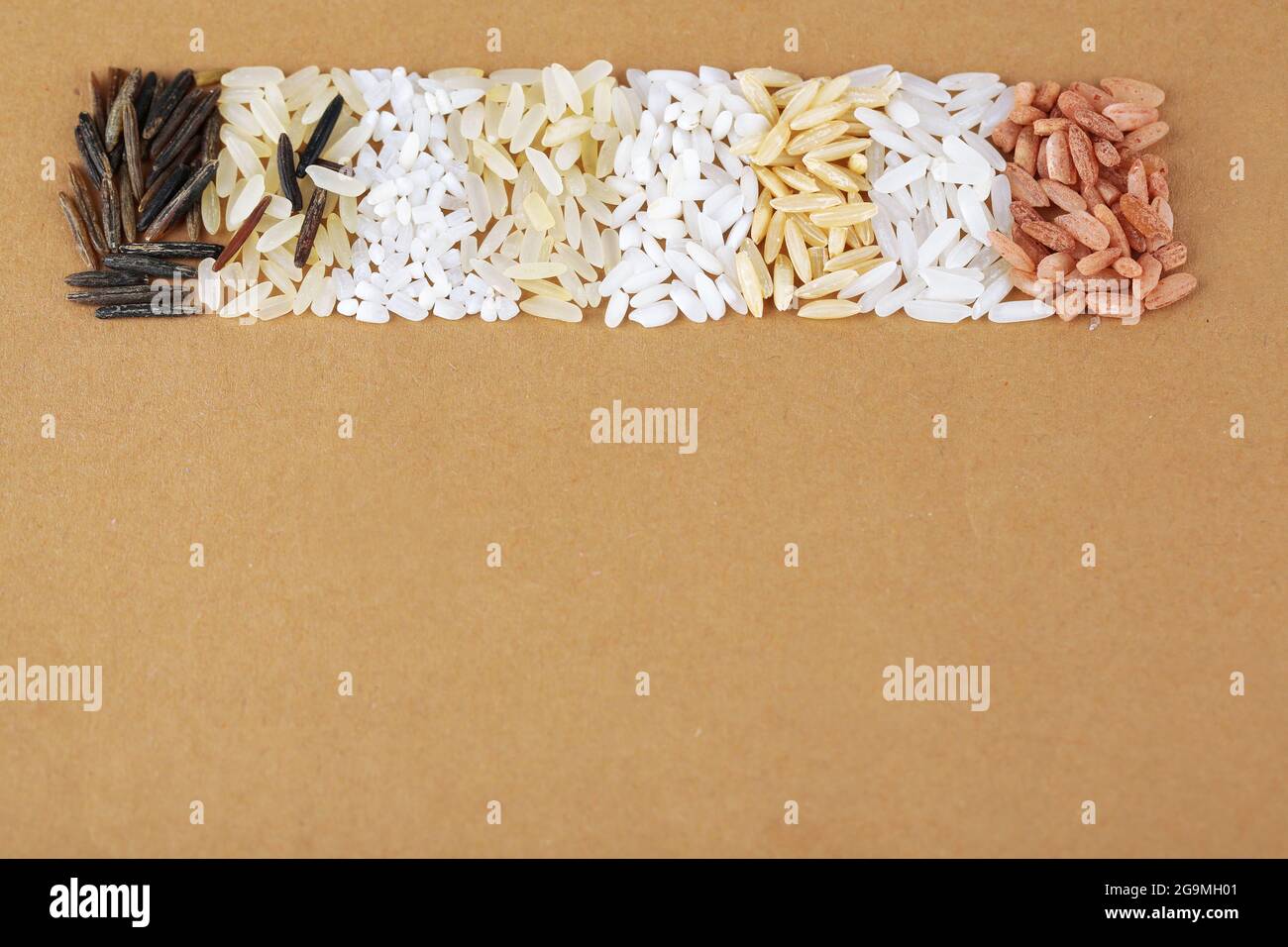 different types of rice on brown background Stock Photo - Alamy