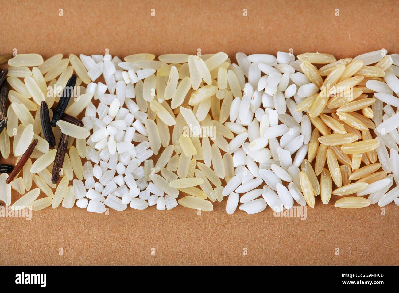 different types of rice on brown background Stock Photo - Alamy