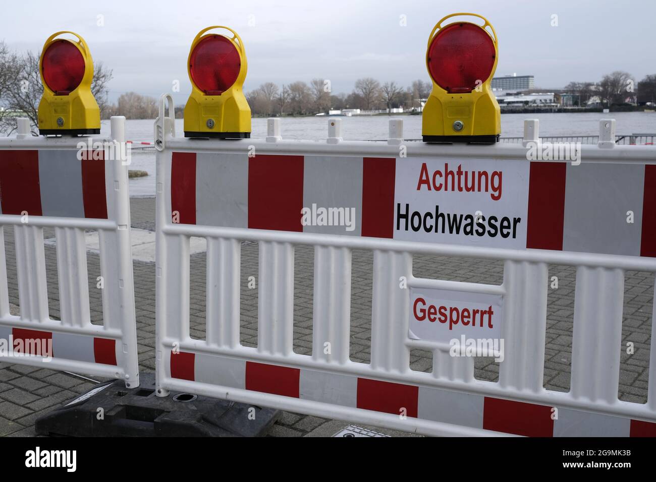 Warning fencing barrier with the text 'achtung hochwasser, gesperrt' in Cologne, Germany Stock Photo