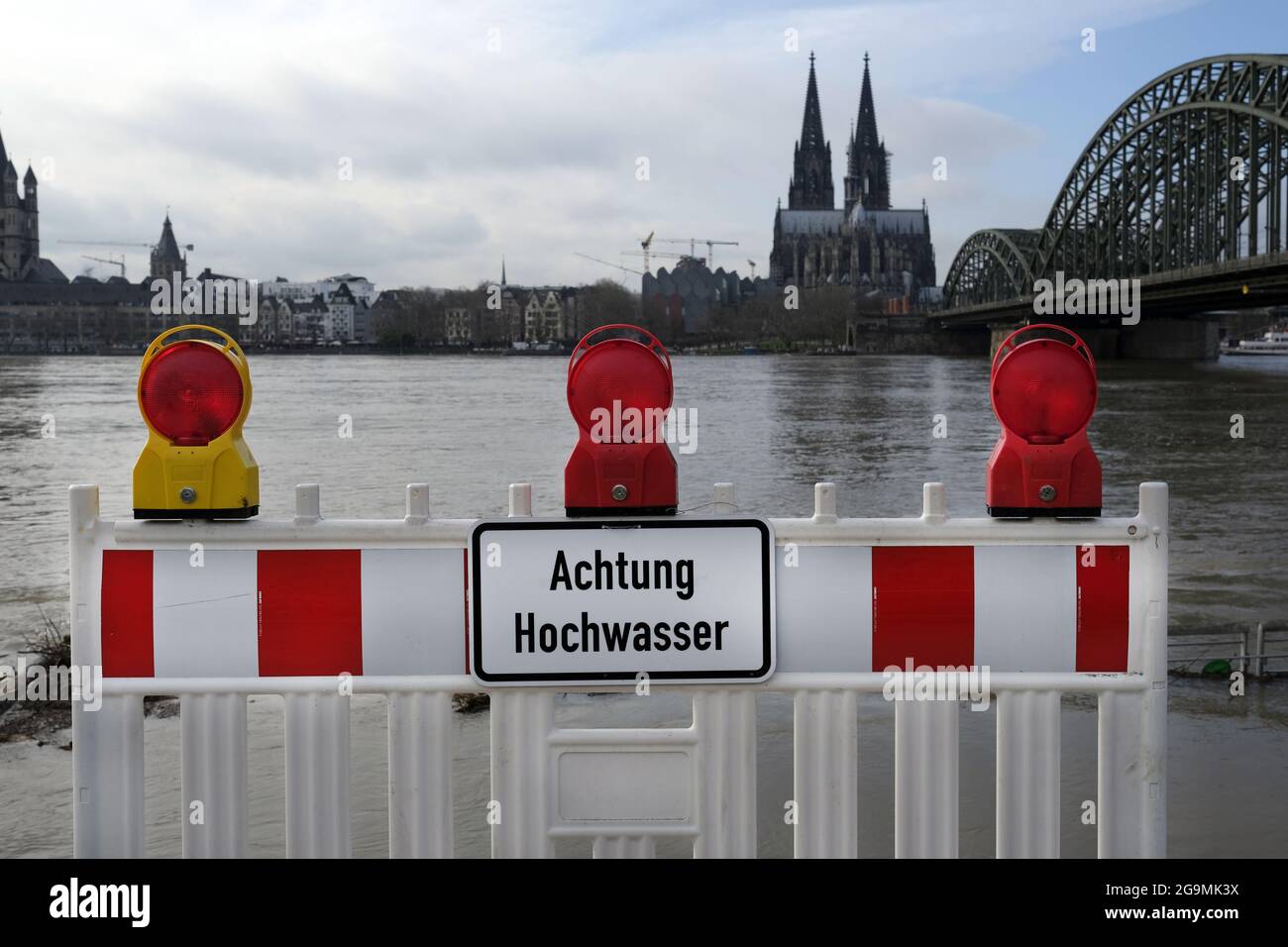 Warning fencing barrier with the text 'achtung hochwasser' in Cologne, Germany Stock Photo