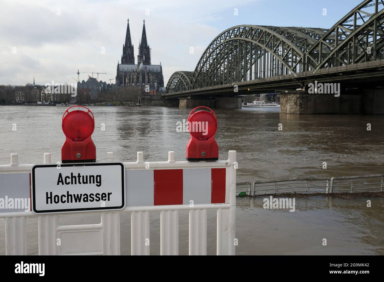 Warning fencing barrier with the text 'achtung hochwasser' in Cologne, Germany Stock Photo