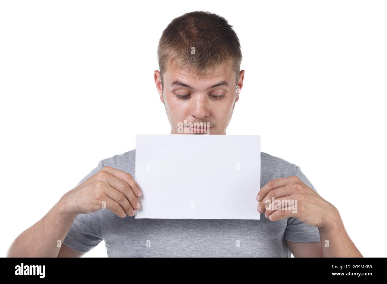 Photo of bristle man holding white empty paper sheet Stock Photo