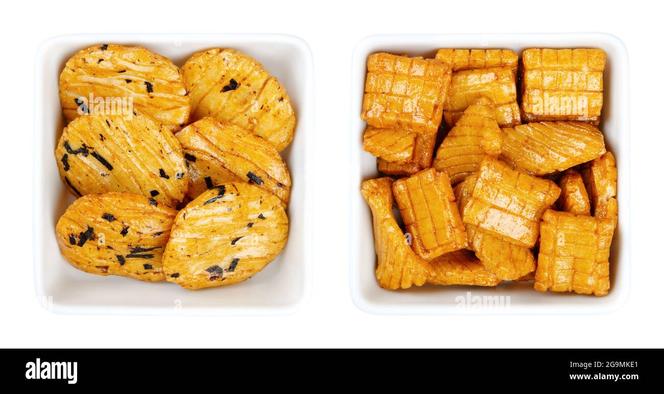 Senbei, Japanese rice crackers in white square bowls. Also sembei, crispy, bite-sized, savory snacks in various shapes and sizes, slightly salted. Stock Photo