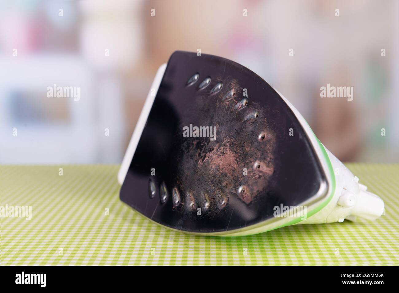 Flat iron with burnt mark on table on bright background Stock Photo Alamy