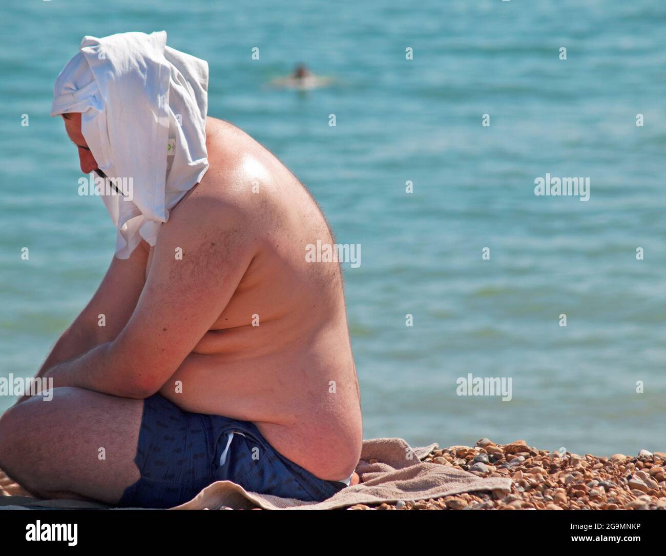 Sunbathing on a hot summer's day at Brighton beach Stock Photo