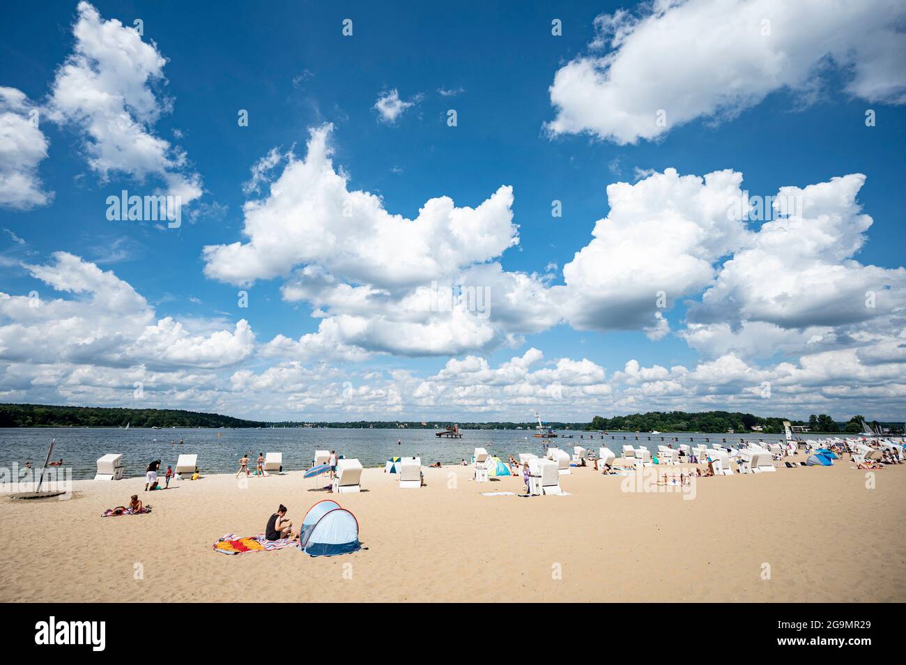 27 July 2021, Berlin: Visitors of the lido at Wannsee enjoy the sunny weather at the water. Photo: Fabian Sommer/dpa Stock Photo