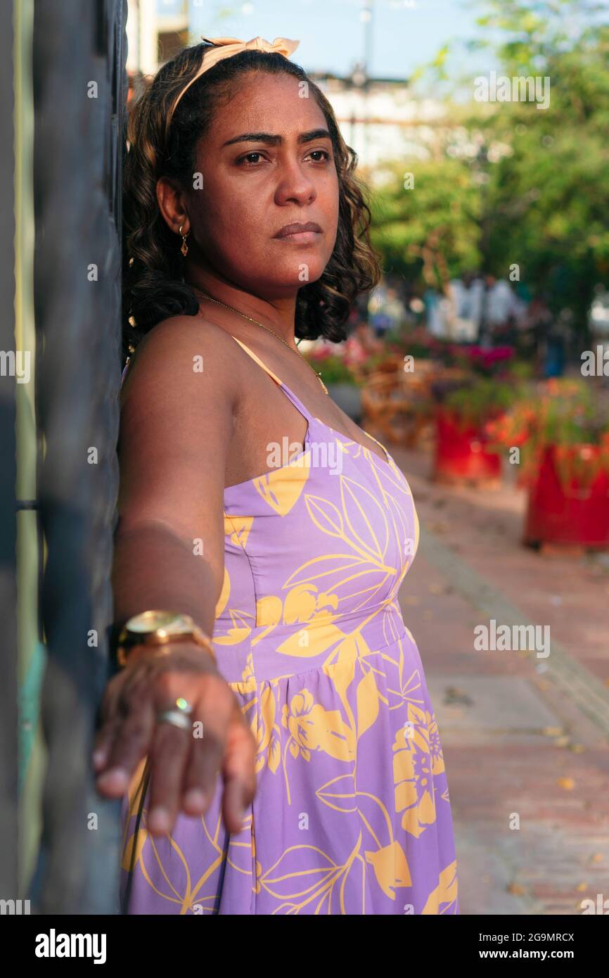 Portrait of a brunette woman in the street Stock Photo - Alamy