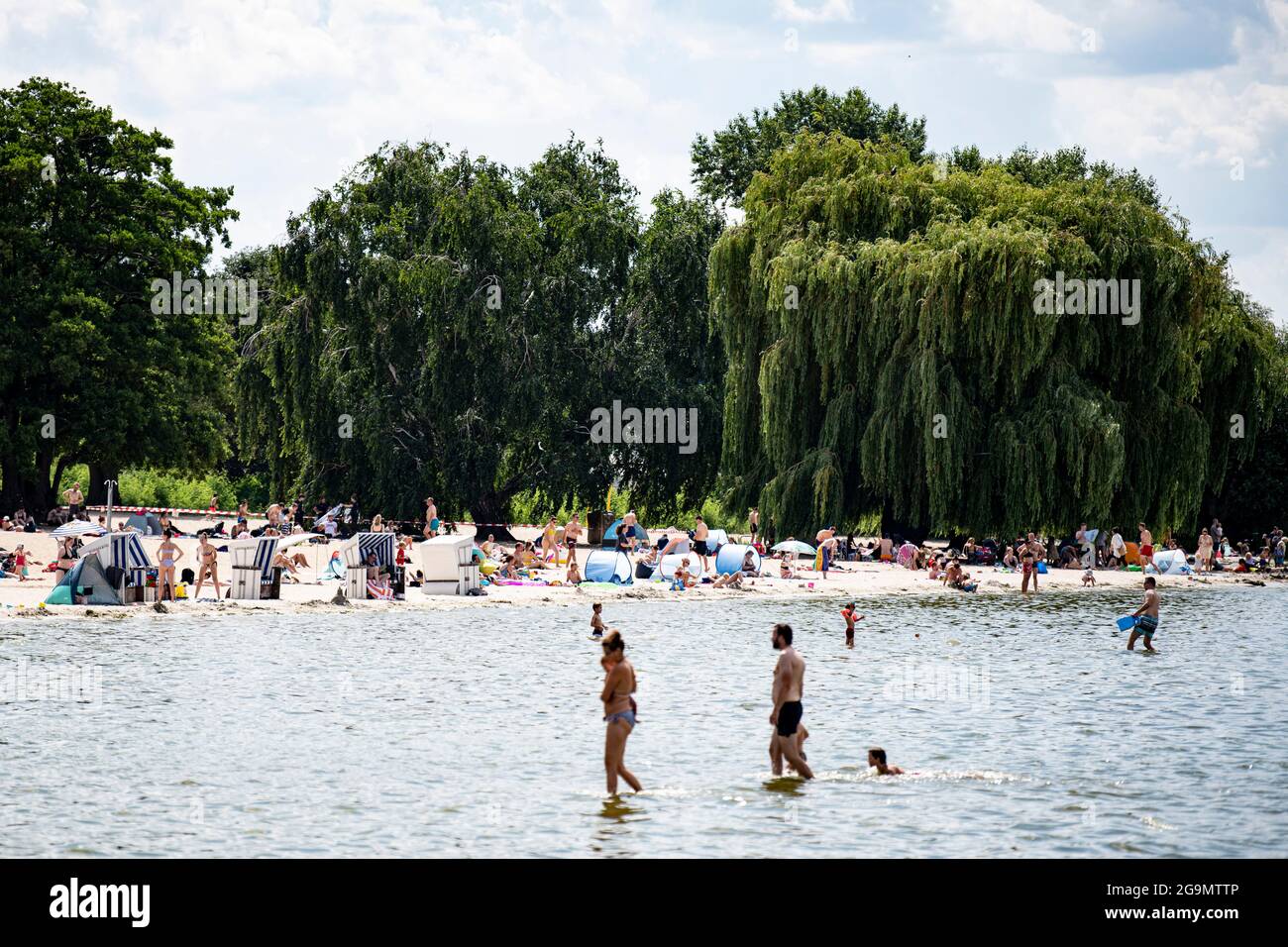 Berlin, Germany. 27th July, 2021. Visitors of the lido at Wannsee enjoy the sunny weather at the water. Credit: Fabian Sommer/dpa/Alamy Live News Stock Photo