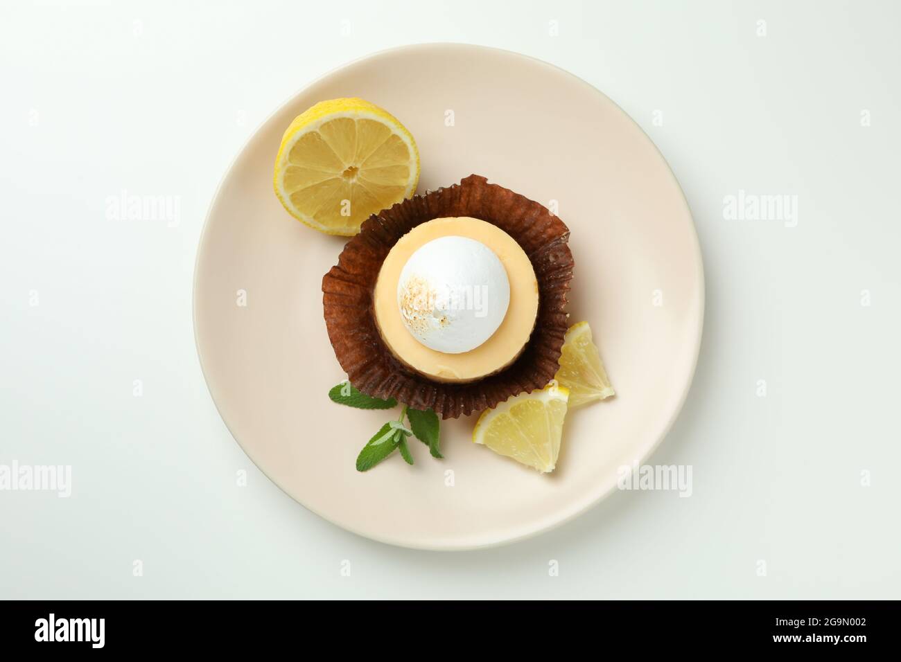 Plate with lemon cupcake on white background Stock Photo
