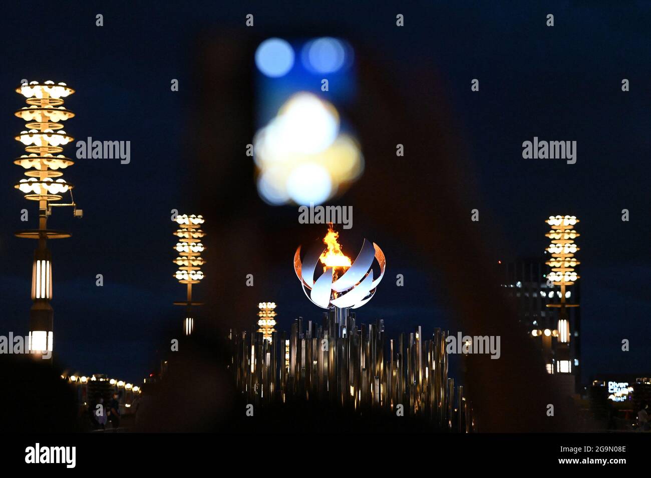 27 July 2021, Japan, Tokio: The Olympic fire is burning. The 2020 Tokyo Olympic Games will take place from 23.07.2021 to 08.08.2021. Photo: Swen Pförtner/dpa Stock Photo