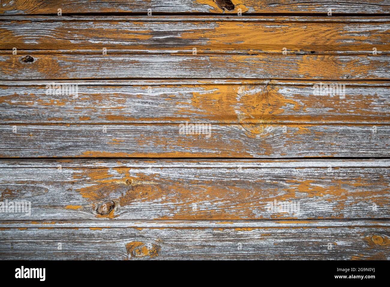 Old weathered board painted yellow, abstract background Stock Photo