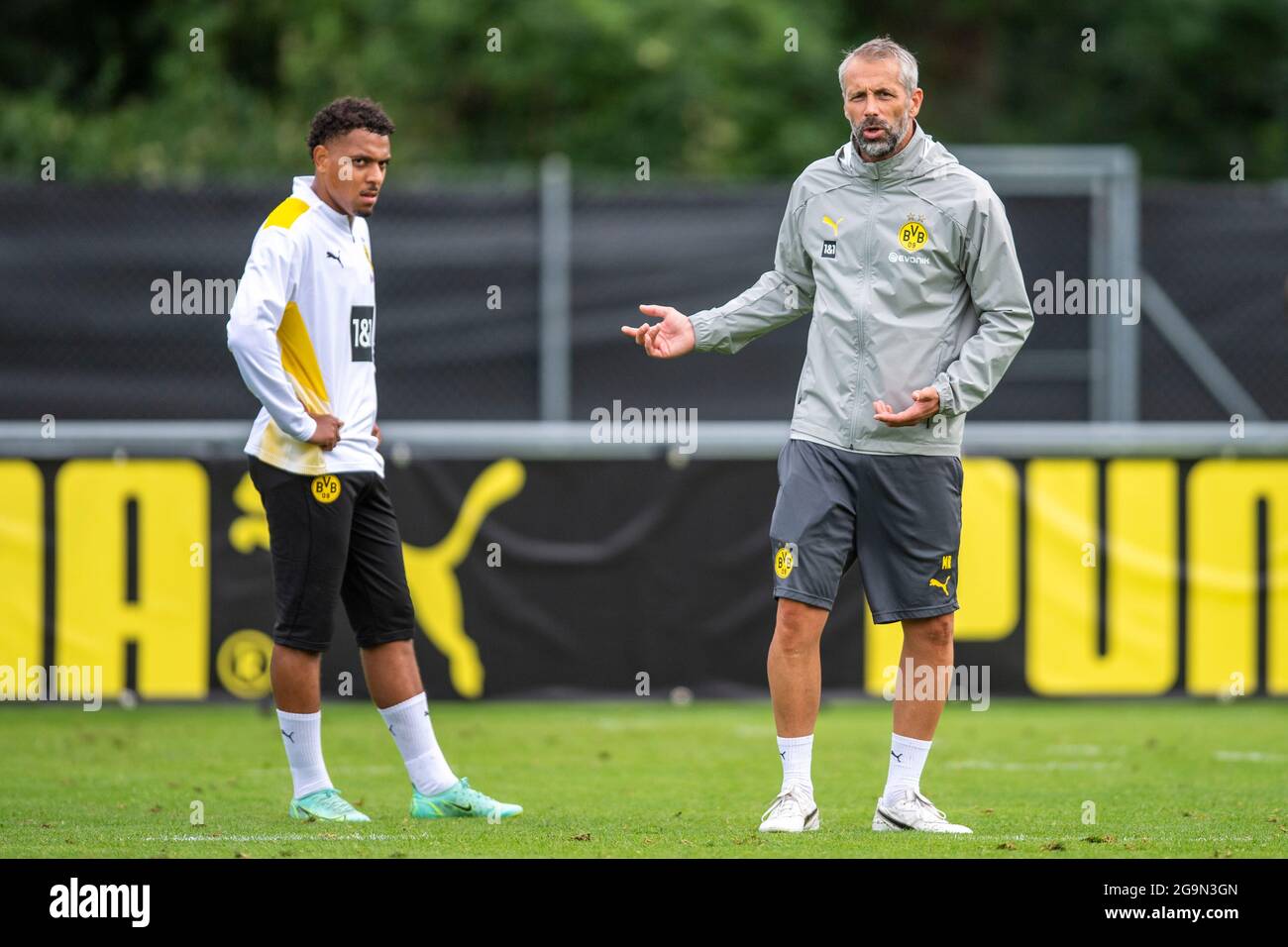 27 July 2021, Switzerland, Bad Ragaz: Football: Bundesliga, Borussia  Dortmund training camp at the Ri-Au sports ground. Donyell Malen (l) talks  to coach Marco Rose. On Tuesday morning, the Dutch international from