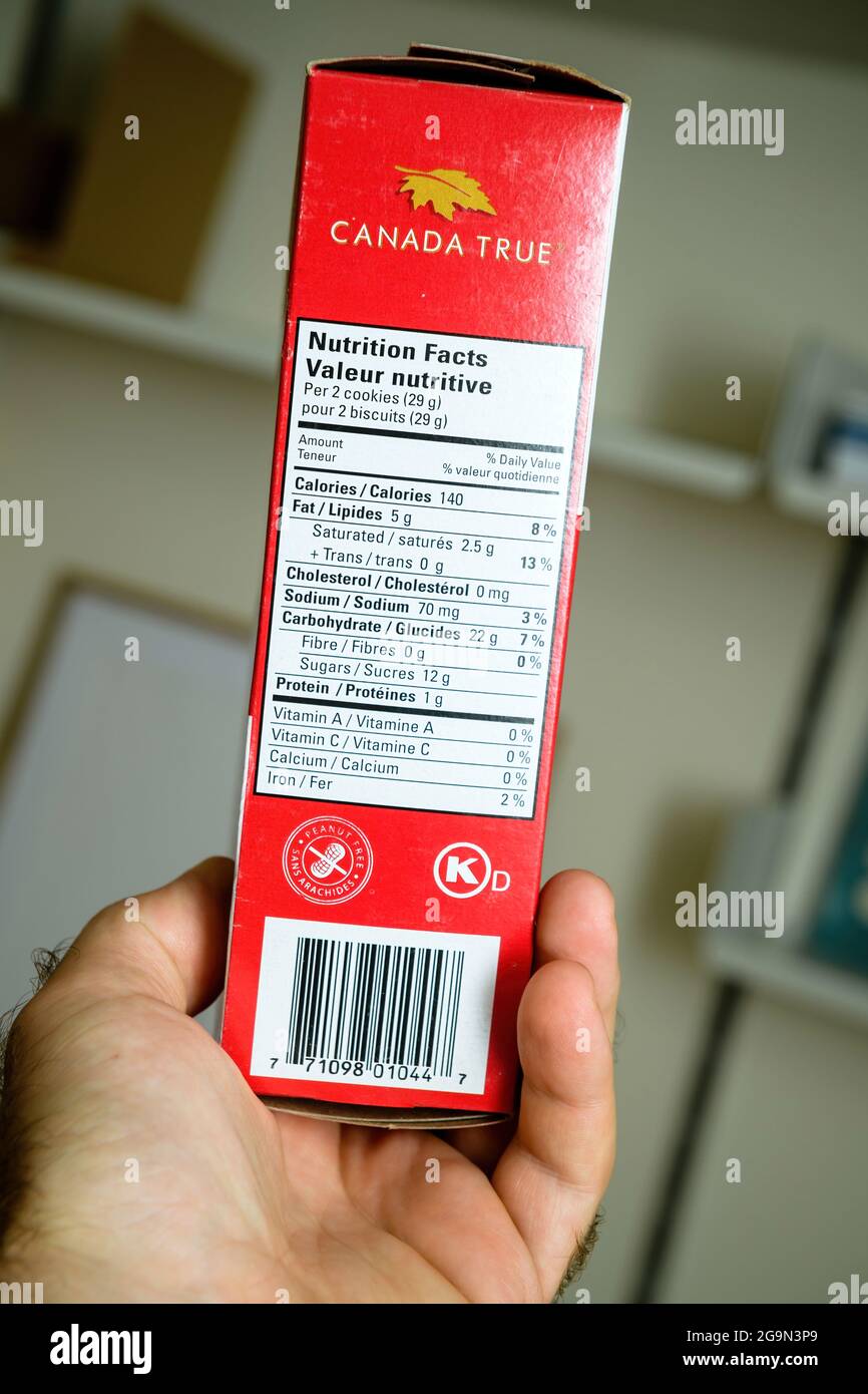 POV male hand holding package with Canada True Nutrition facts Stock Photo