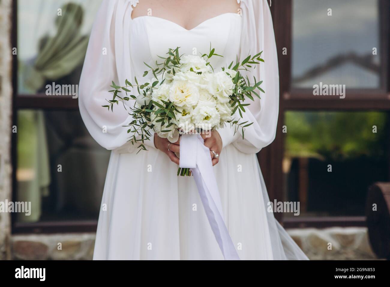 White bridal bouquet of peonies and roses in bride hands Stock Photo ...
