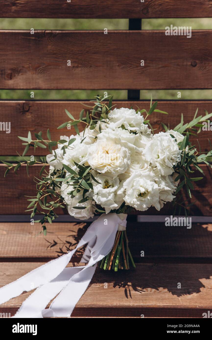 White bridal bouquet of peonies and roses. Scenery for the wedding ...