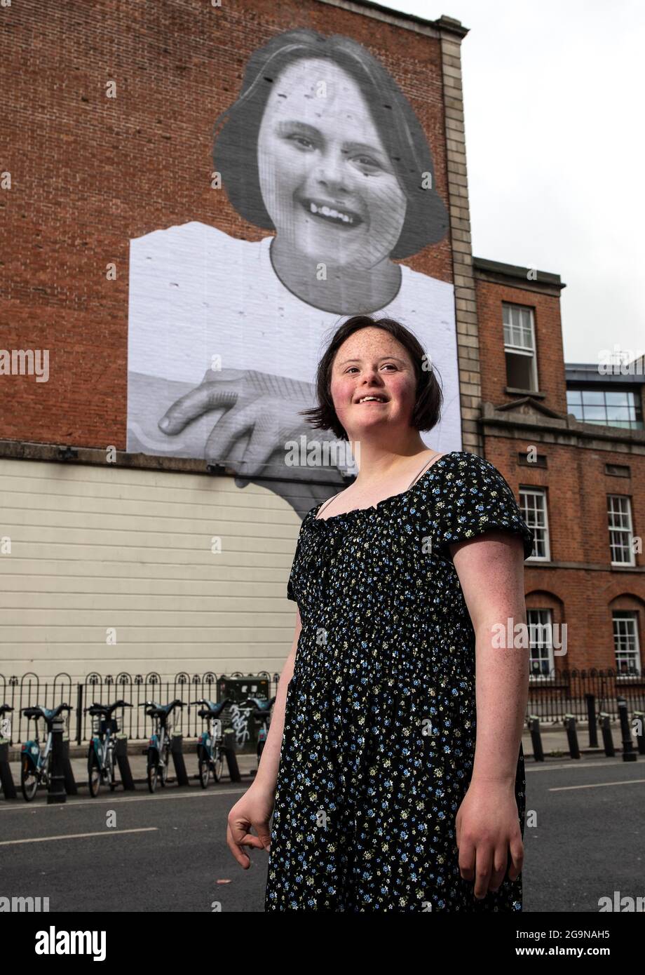 21-year-old Amanda Butler, from Mullingar, stands beside a street artwork  of herself by renowned artist and activist Joe Caslin in Dublin City  Centre. Down Syndrome Ireland has today kicked off its 50-year