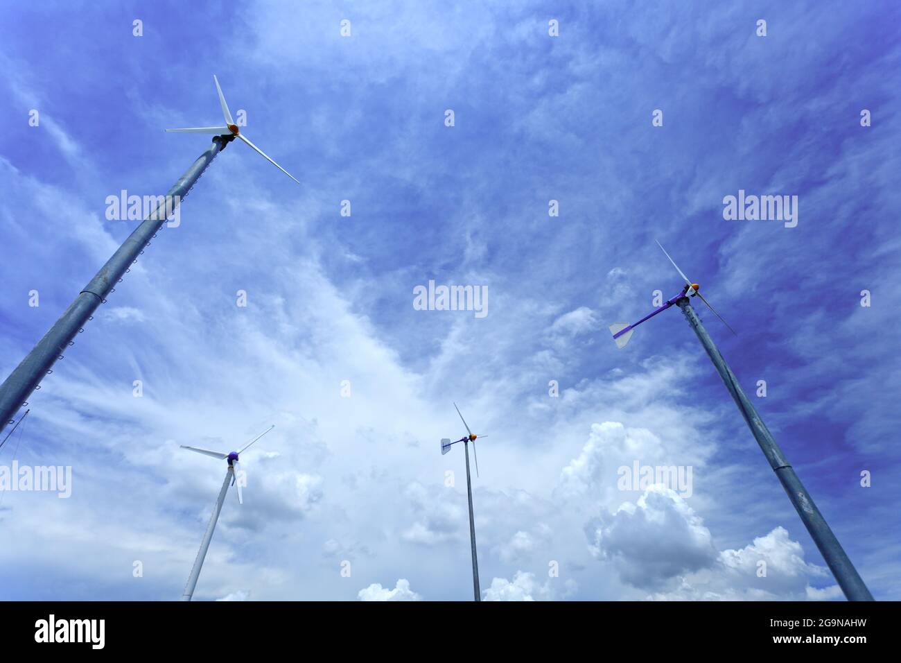 Wind turbine and clouds in blue sky Stock Photo - Alamy