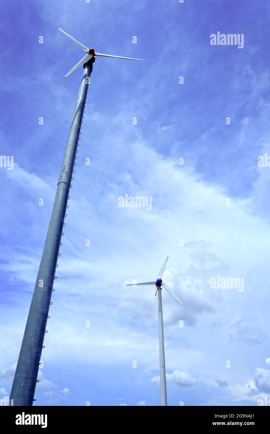 Wind turbine and clouds in blue sky Stock Photo - Alamy